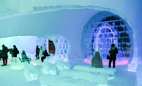 People visit ice bar in Harbin's Ice-Snow World