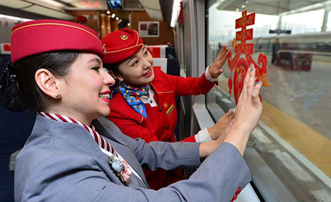 Foreign volunteers serve passengers during Chunyun