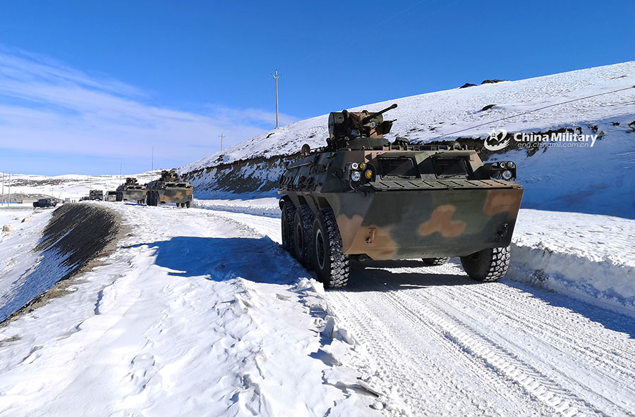 Armored vehicles maneuver in snow-covered area