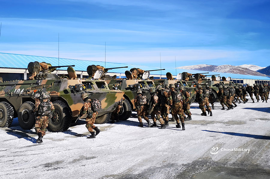 Armored vehicles maneuver in snow-covered area