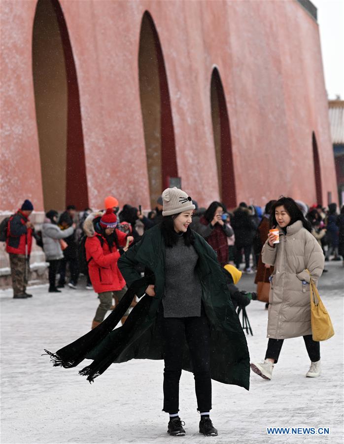 Visitors view snowy scenery at Palace Museum in Beijing