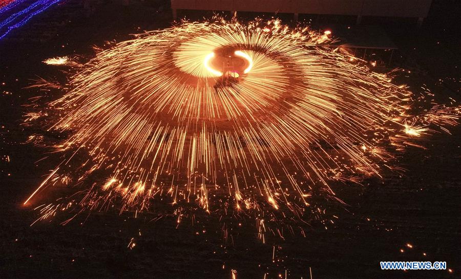 Performers throw molten iron to create fireworks ahead of Lantern Festival in Hebei