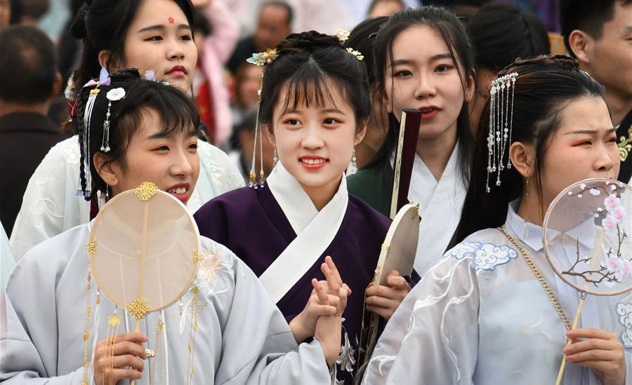Women wearing traditional costumes take part in parade