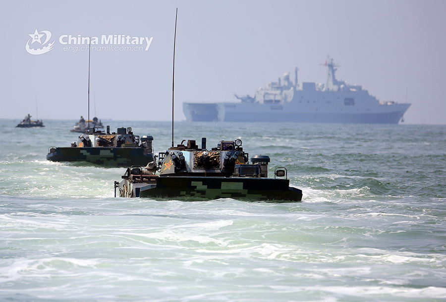 Amphibious armored vehicles in beach raid training