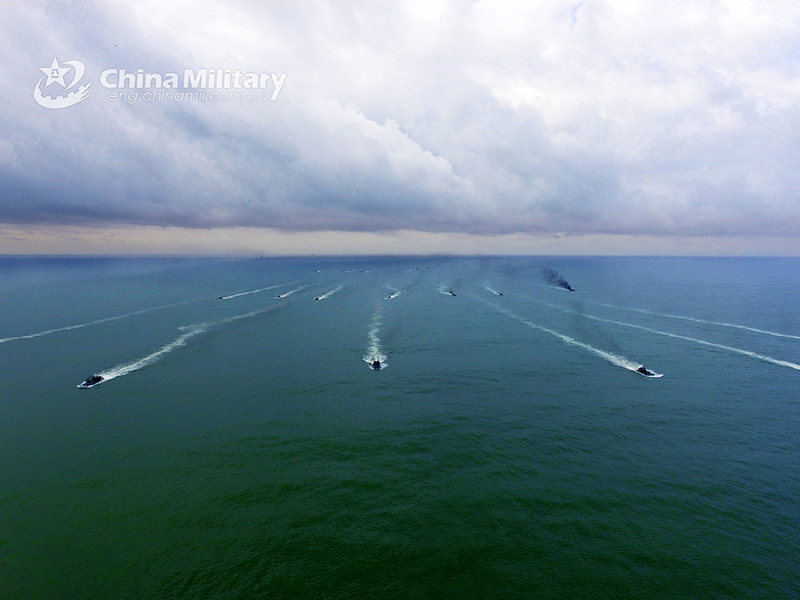 Amphibious armored vehicles in beach raid training