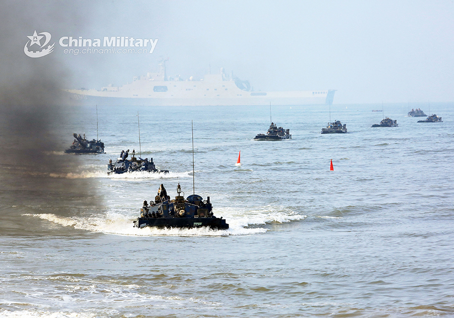 Amphibious armored vehicles in beach raid training