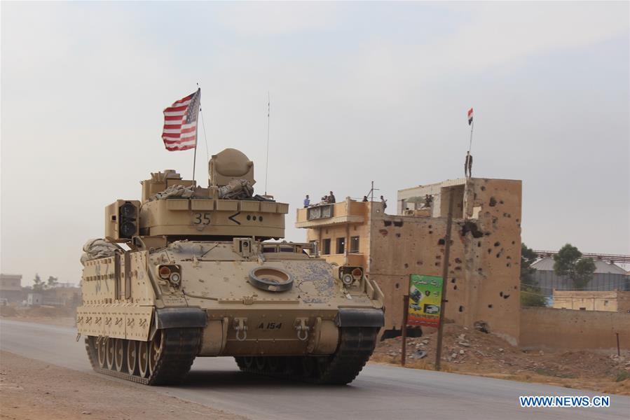 U.S. military vehicle runs past countryside of Hasakah province, NE Syria