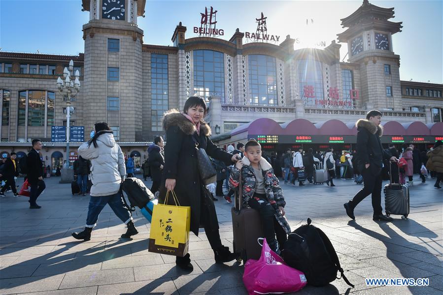 Passengers bring gifts for families as they head home for Spring Festival