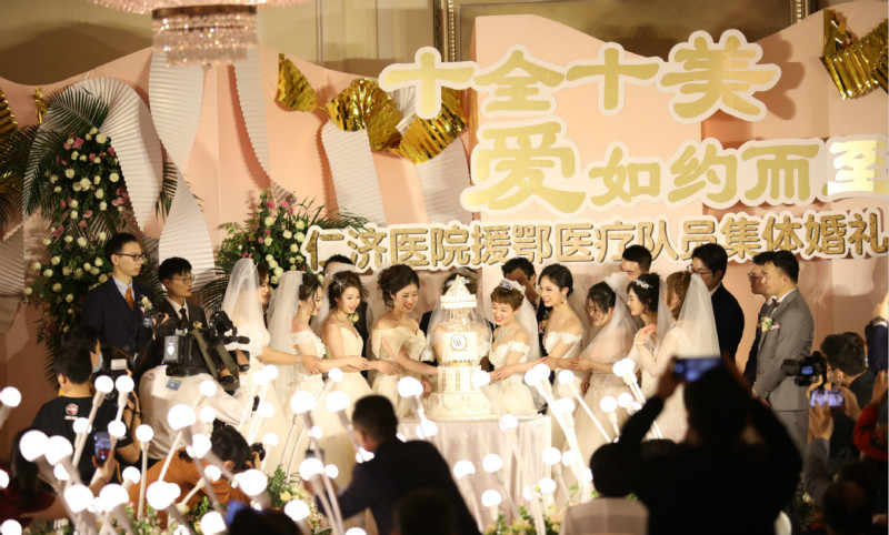 Historic hotel holds mass ceremony for medics delaying weddings