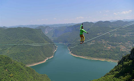 Man balances on highline at outdoor sports base in Hubei