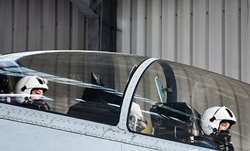 Fighter jet flies to designated air space