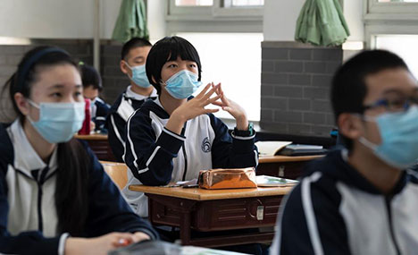 Graduating students in Beijing return to school