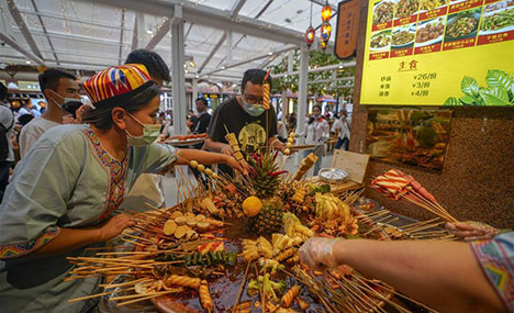 People visit Grand Bazaar Food Street in Urumqi, Xinjiang