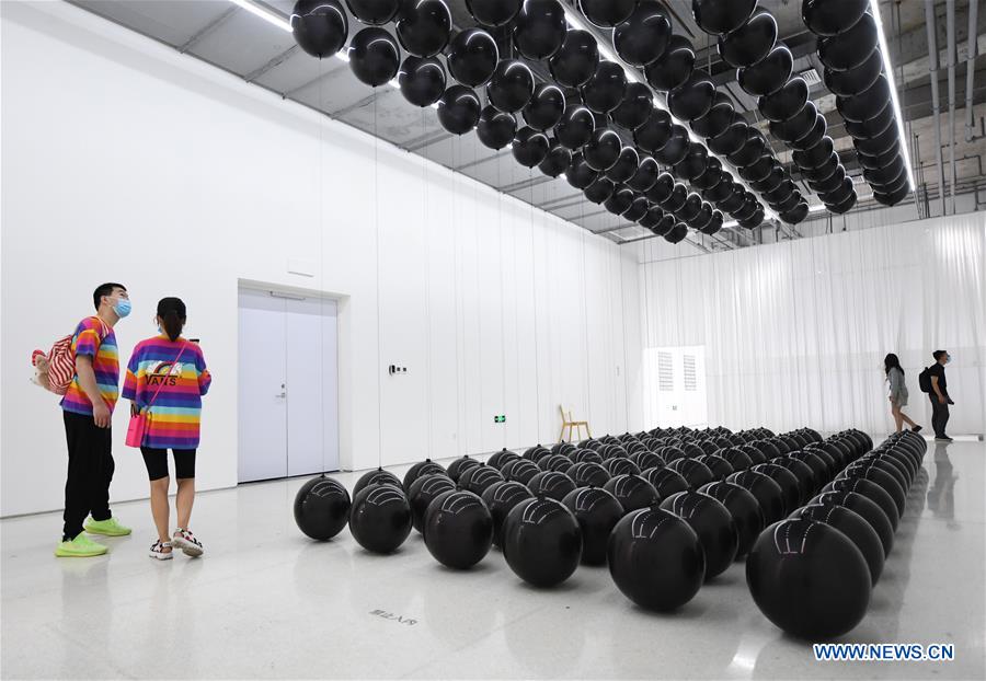 Visitors view contemporary art exhibition at Times Art Museum in Beijing