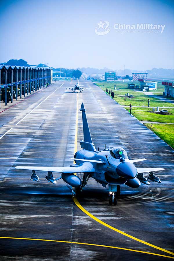 Fighter jets head for take-off on taxiway before flight