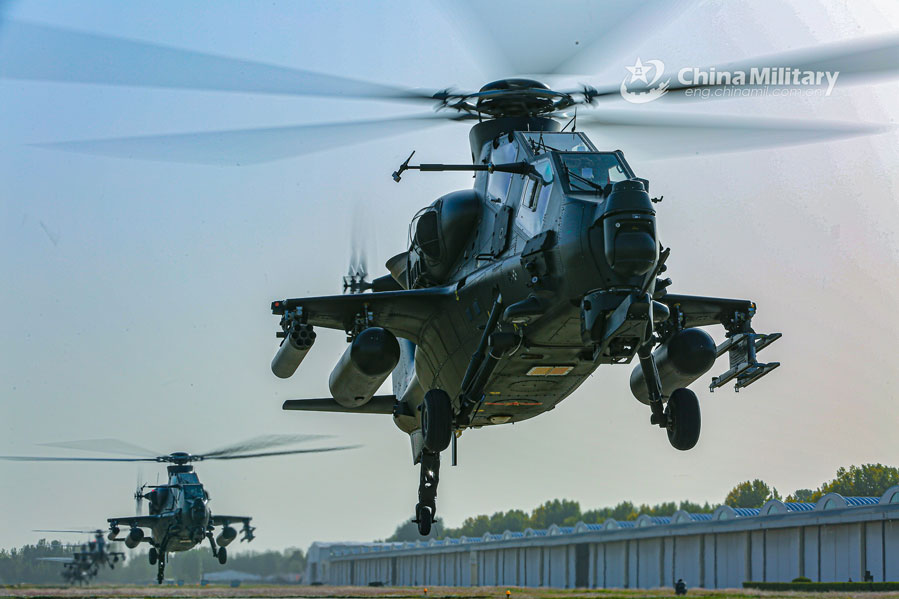 Multi-type attack helicopters hover at low altitude