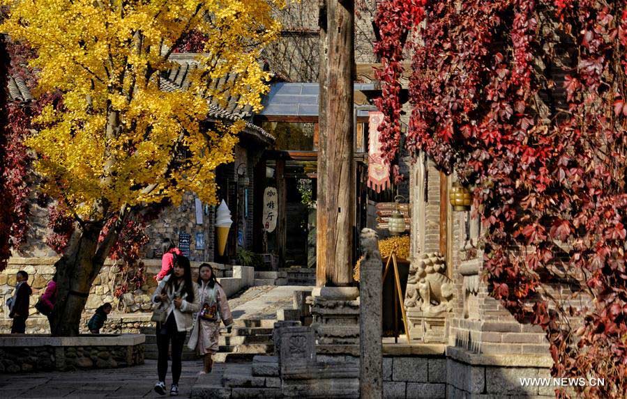People enjoy autumn scenery in Gubei Water Town in Beijing