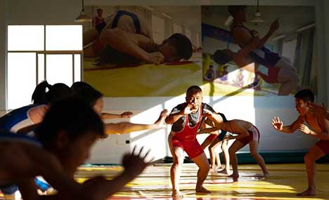 Pic story: principal of school trains hundreds of wrestlers
