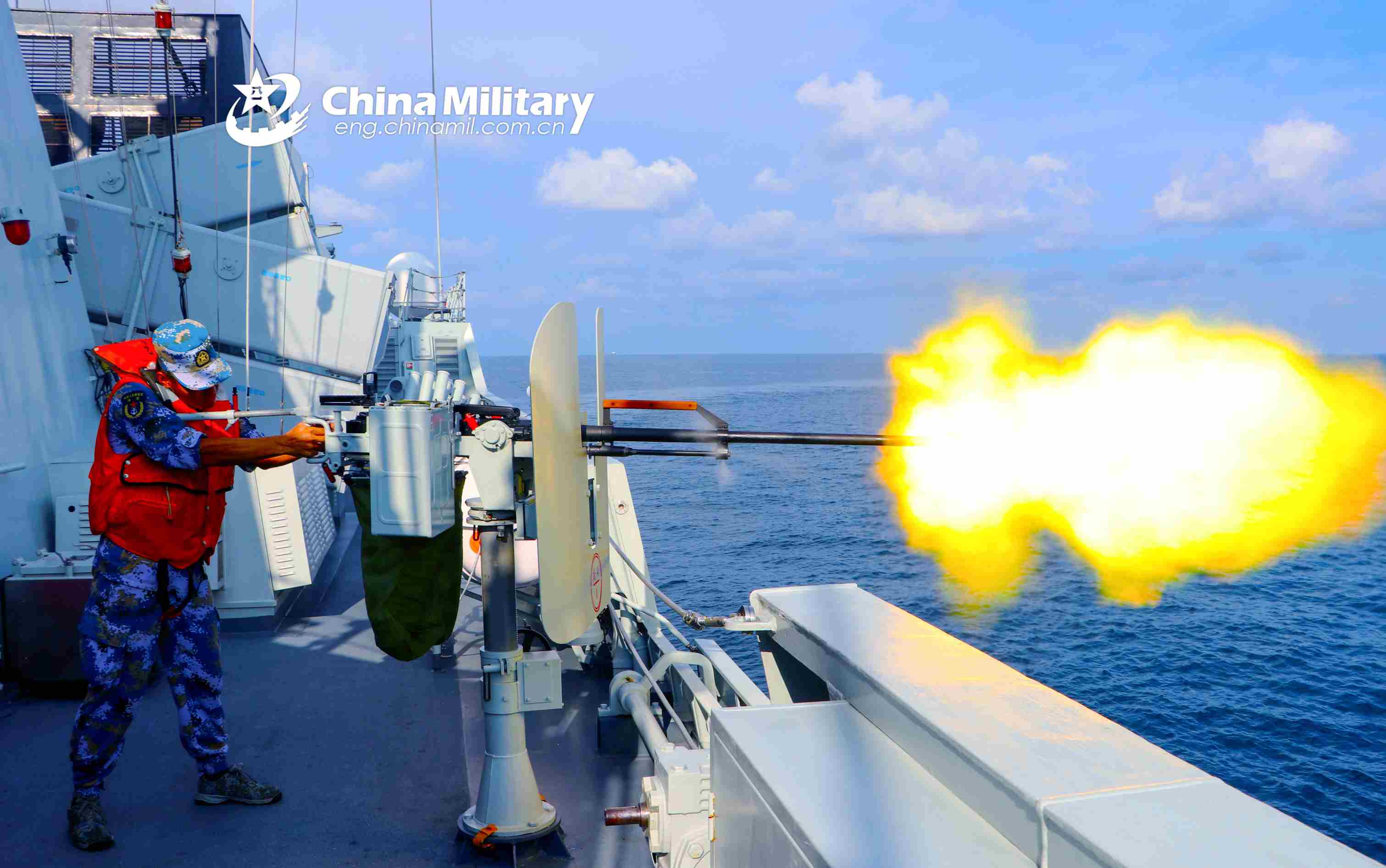 Sailor fires heavy machine gun aboard frigate
