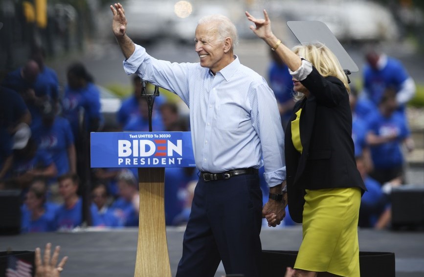 Biden urges Americans to "turn the page" after Electoral College victory