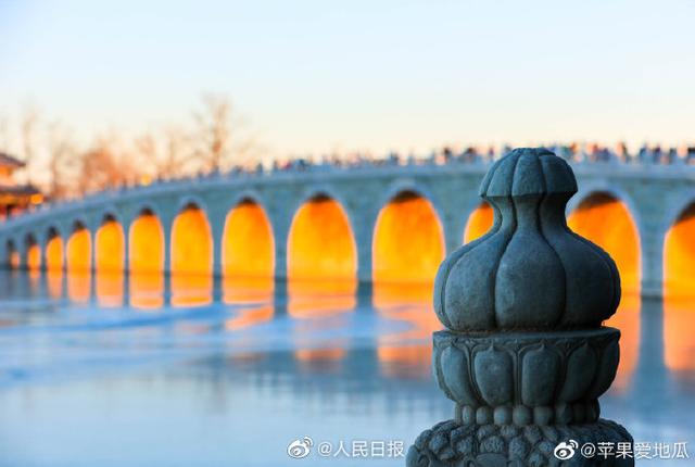 Stunning view of ancient bridge lit by golden winter sunshine at the Summer Palace in Beijing