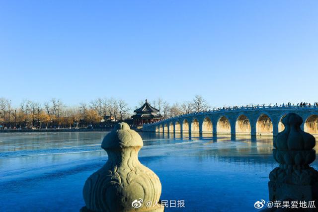 Stunning view of ancient bridge lit by golden winter sunshine at the Summer Palace in Beijing