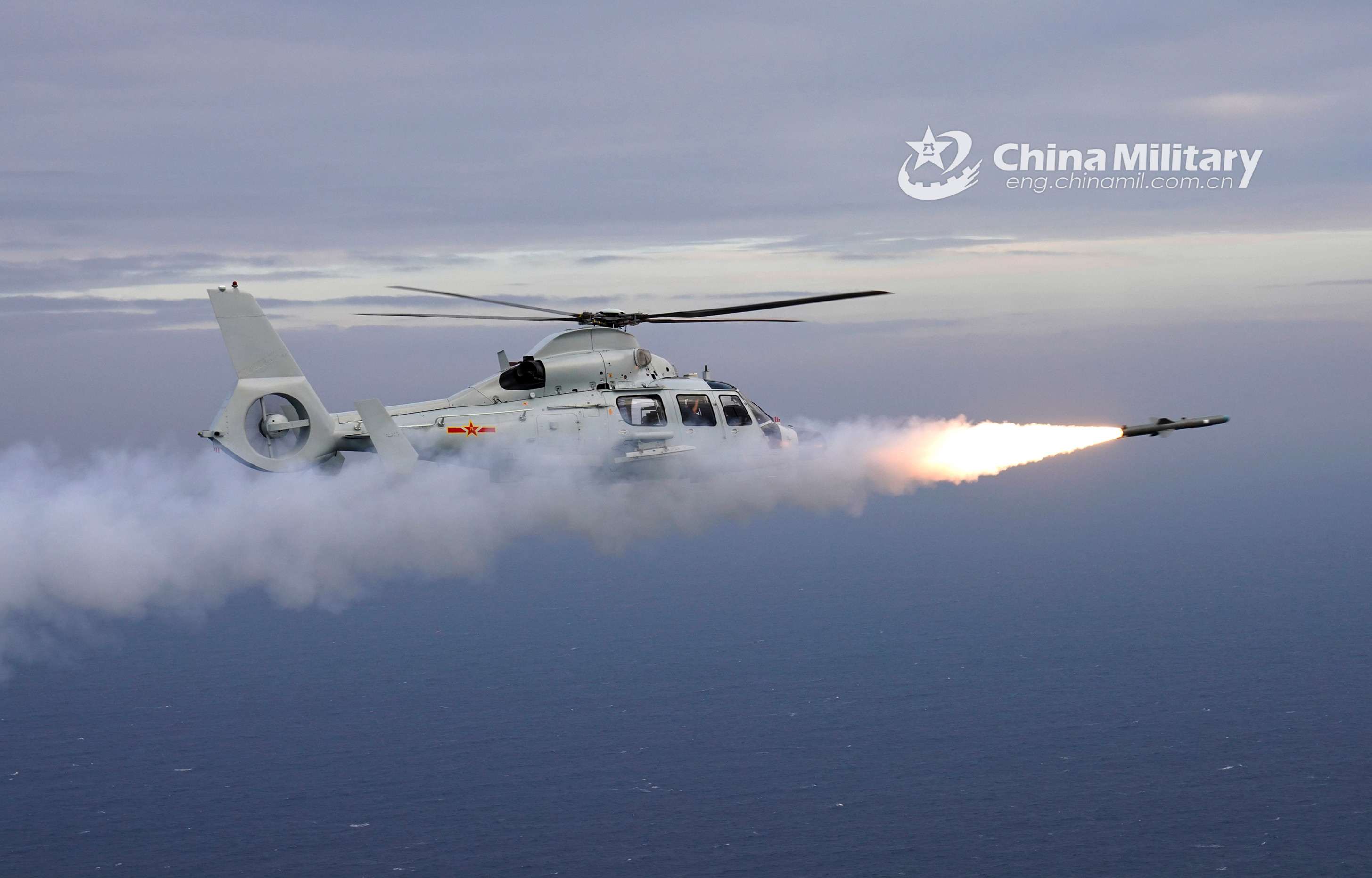 Ship-borne helicopters fire missiles