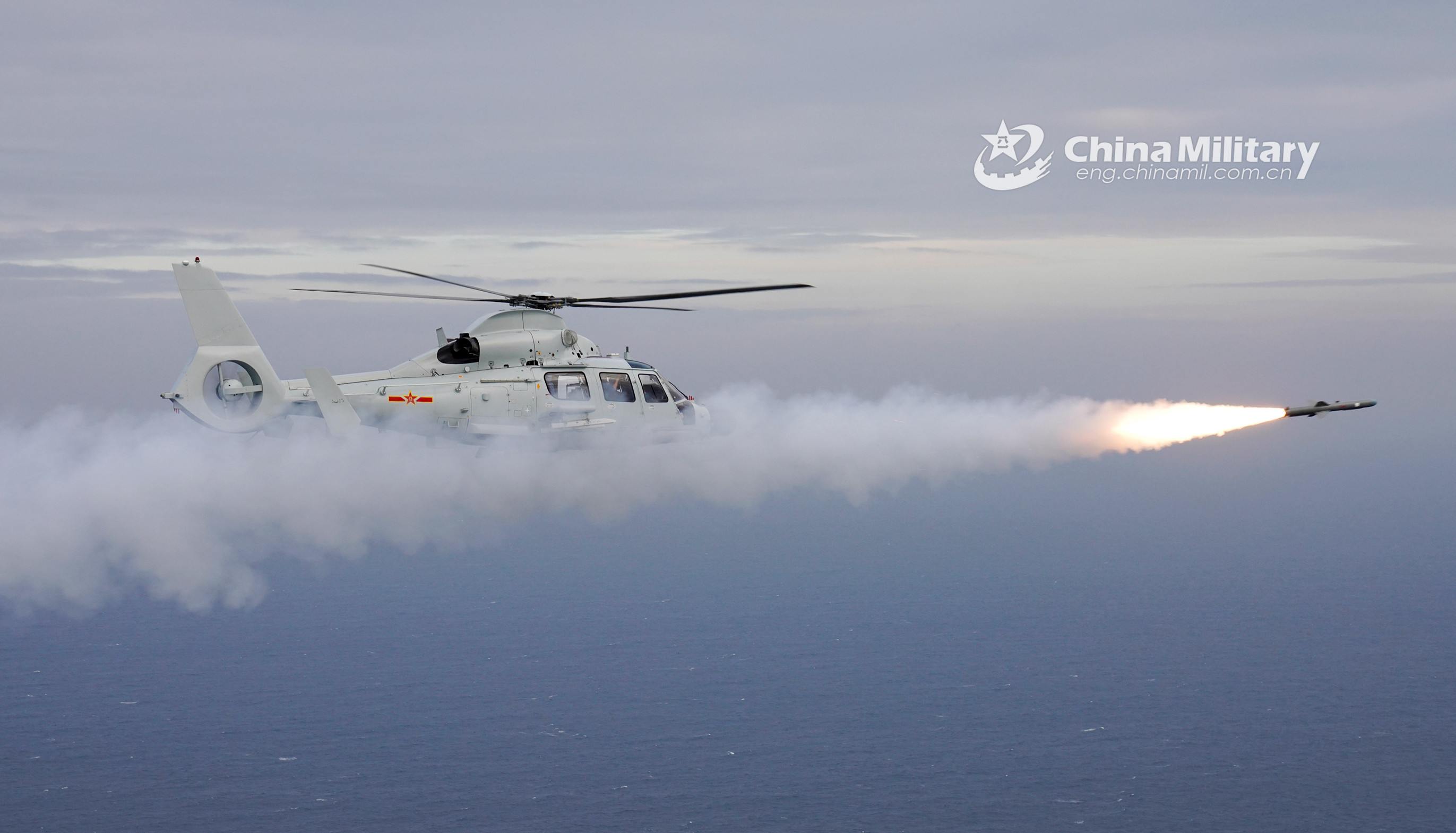 Ship-borne helicopters fire missiles