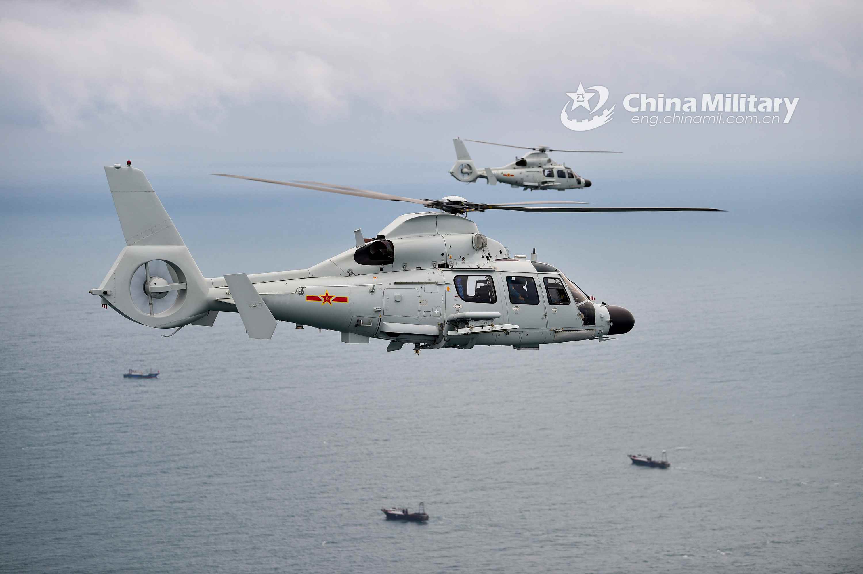 Ship-borne helicopters fire missiles