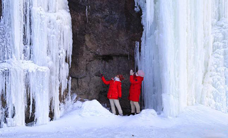Beautiful icefalls on mountain cliffs attract visitors