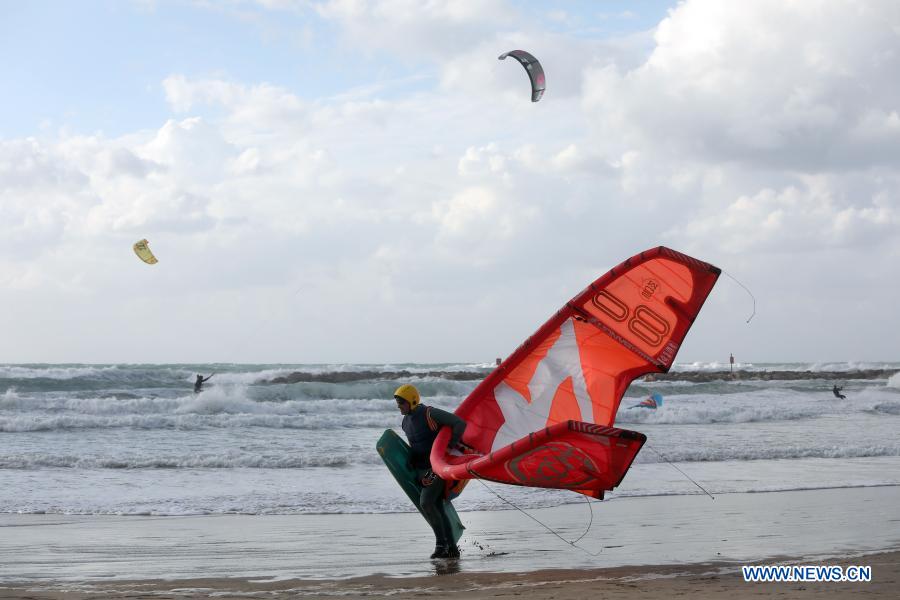 Israeli kite surfers practice on Mediterranean beach