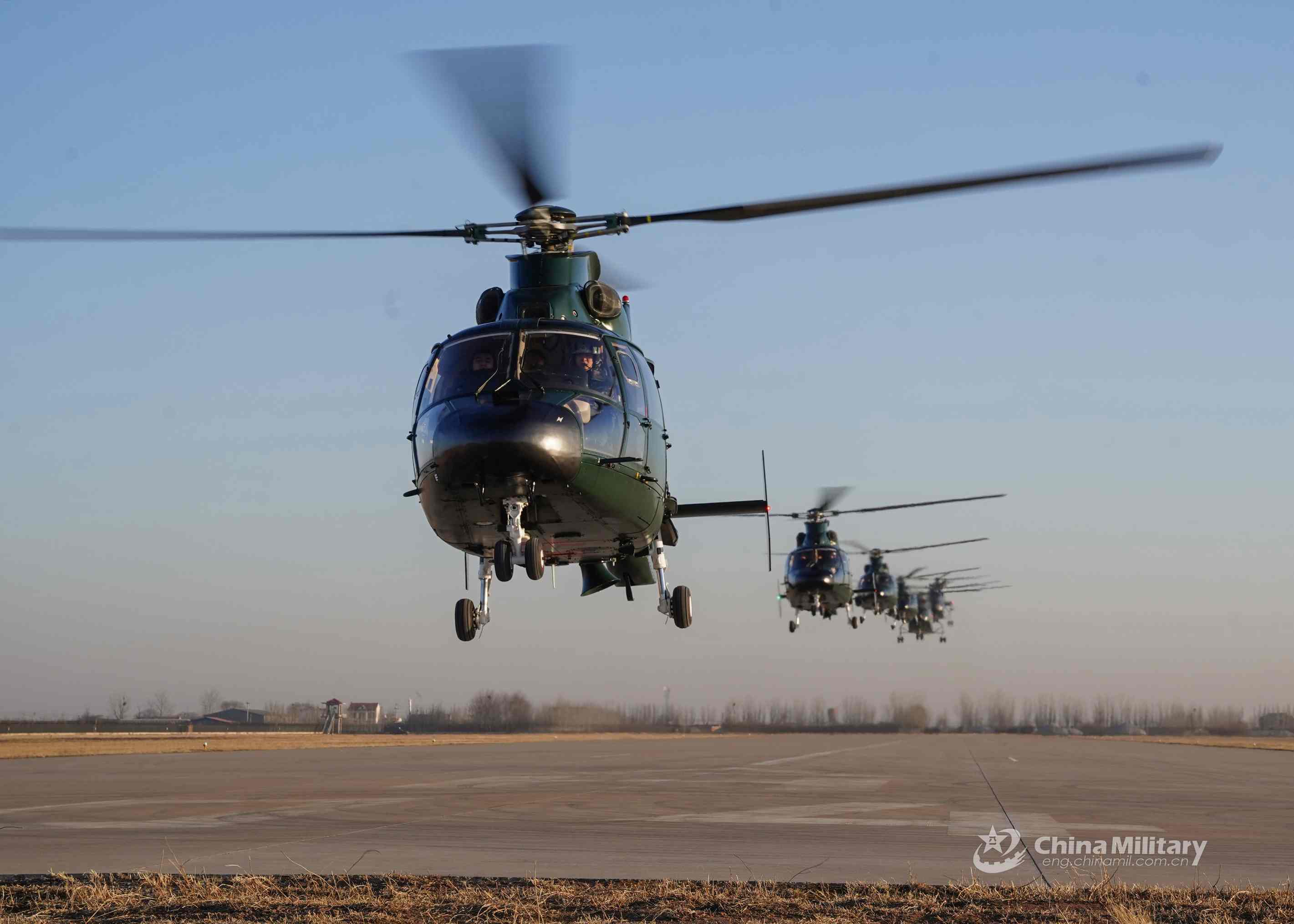 A cluster of Z-9 attack helicopters attached to a detachment with the People's Armed Police (PAP) Force lift off simultaneously for a flight training mission in early January, 2021. (eng.chinamil.com.cn/Photo by Zhang Xi)