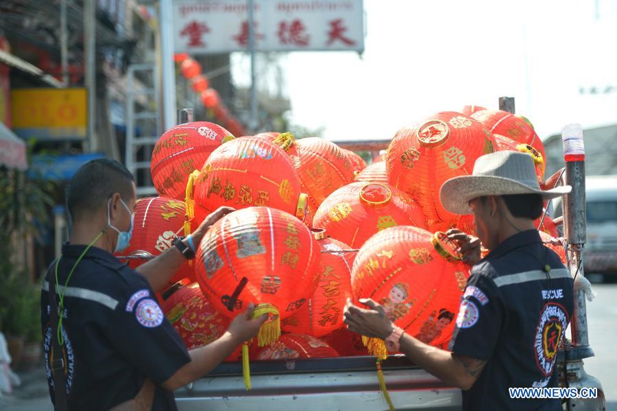 Staff members arrange lanterns to decorate street for upcoming Chinese Lunar New Year