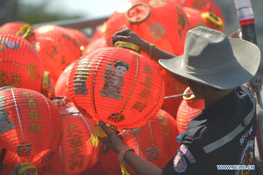 Staff members arrange lanterns to decorate street for upcoming Chinese Lunar New Year