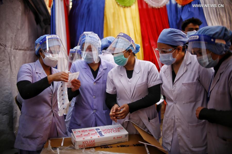 Medical workers work at vaccination room in Kathmandu, Nepal