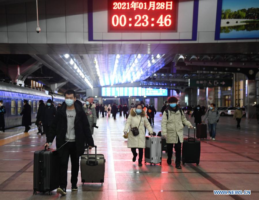 Passengers walk to board their train at the Beijing Railway Station, in Beijing, capital of China, Jan. 28, 2021. The Spring Festival travel rush, known as the world's largest annual human migration, lasts 40 days from Jan. 28 to March 8 this year. (Xinhua/Zhang Chenlin)