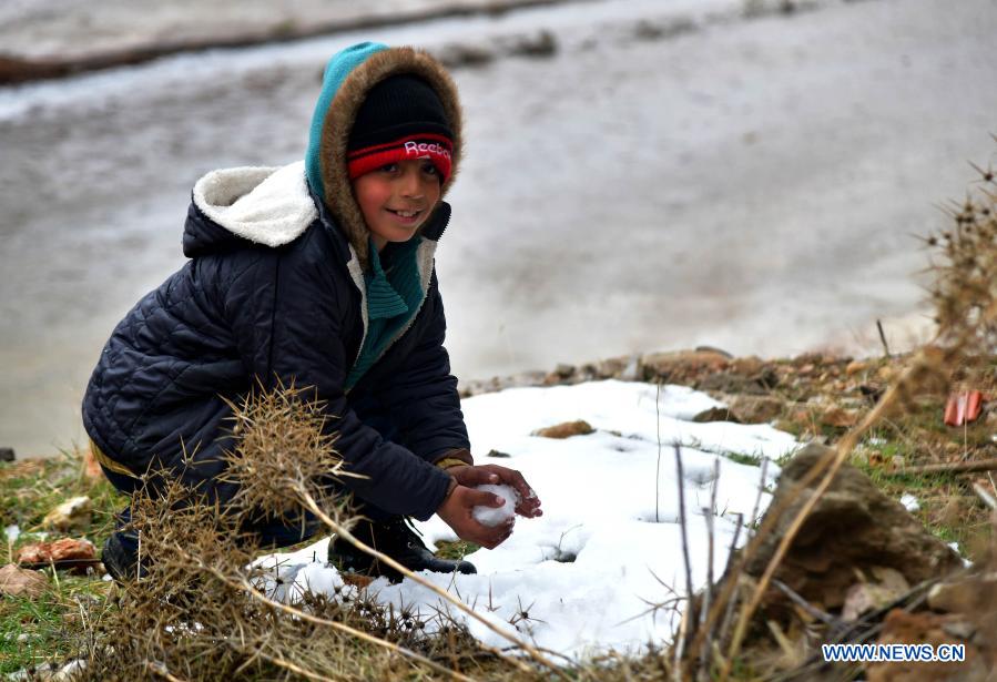 Children play snow in Damascus, Syria