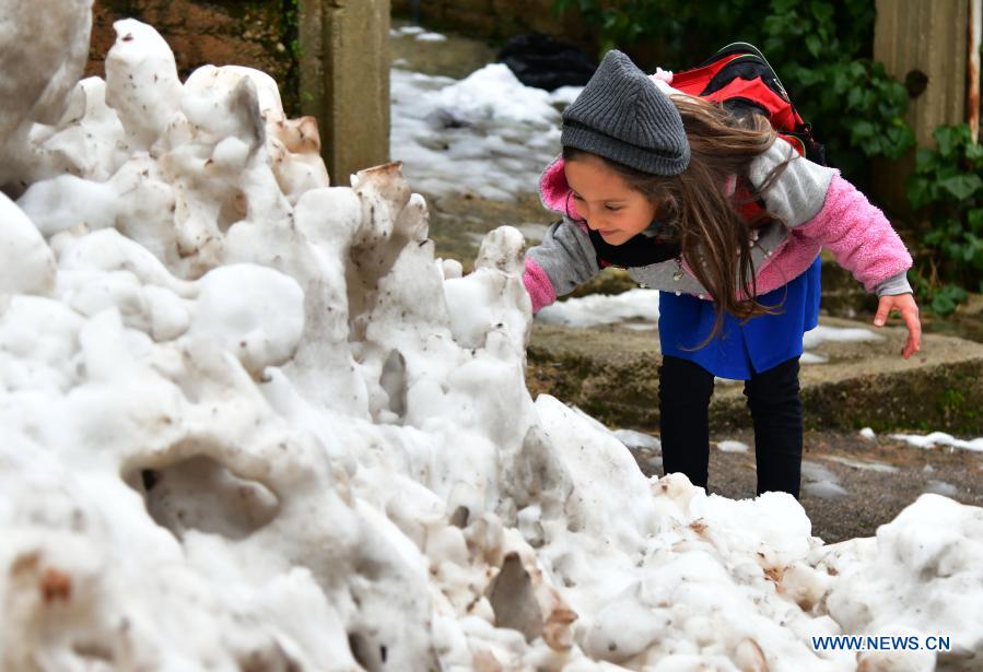 Children play snow in Damascus, Syria