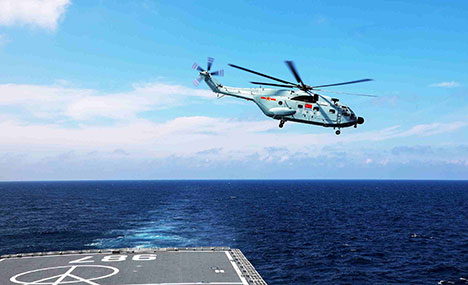Ship-borne helicopter coordinates with dock landing ship