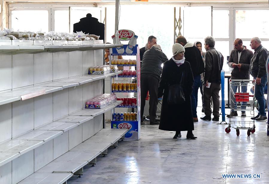 People shop at grocery store in Damascus, Syria
