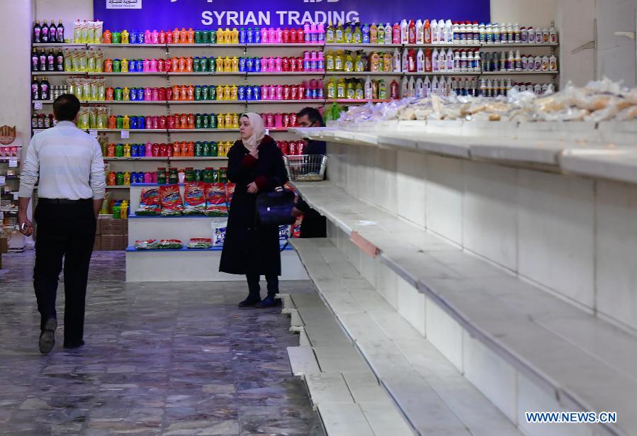 People shop at grocery store in Damascus, Syria