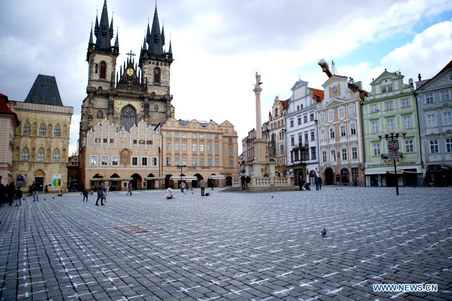 Old Town Square painted with white crosses in memory of victims of COVID-19 pandemic in Prague