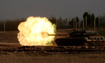 Tanks attack mock targets during live-fire training