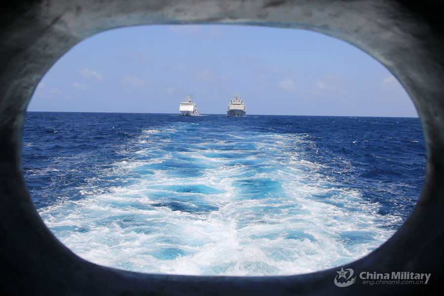 Navy vessels perform underway replenishment