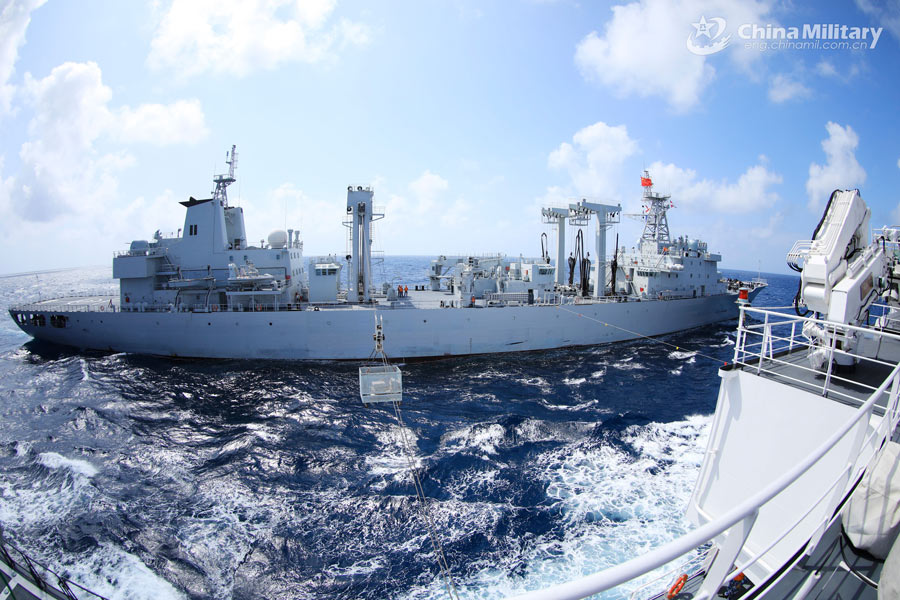 Navy vessels perform underway replenishment