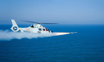 Ship-borne helicopter fires missile at mock target