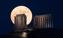 Full moon rises over Temple of Poseidon in Greece