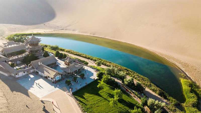 Plants by Crescent Lake turn greener after rain in Dunhuang
