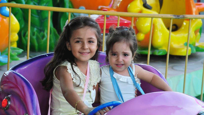 Children play at theme park in Damascus, Syria