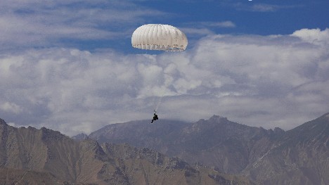 Paratroopers descend from high blue sky